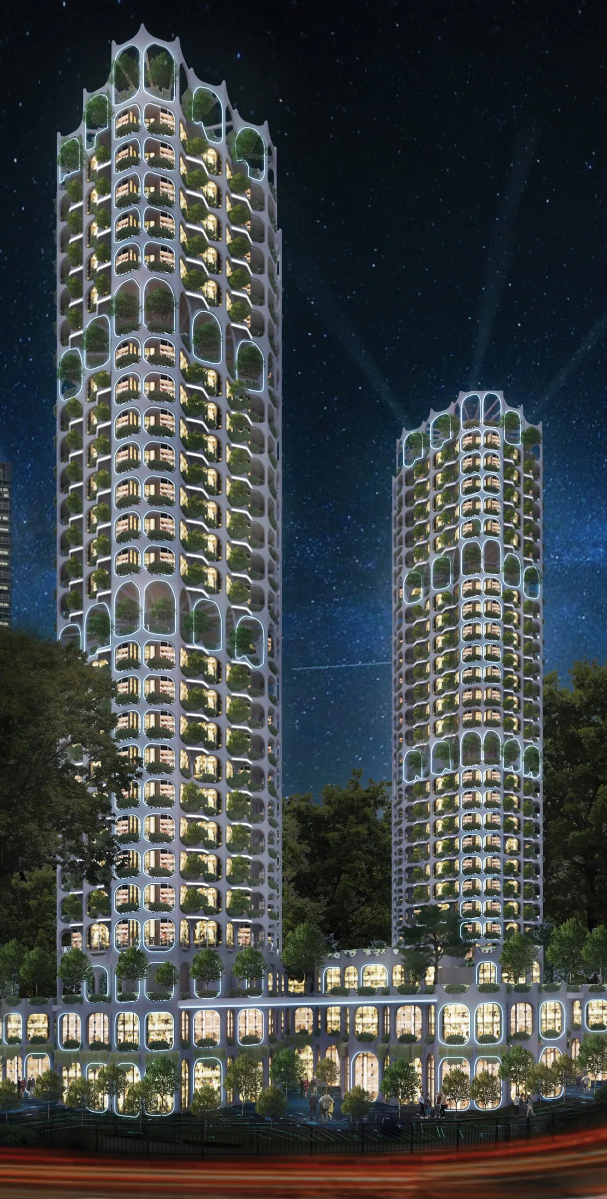 Night render of two green-wrapped residential towers