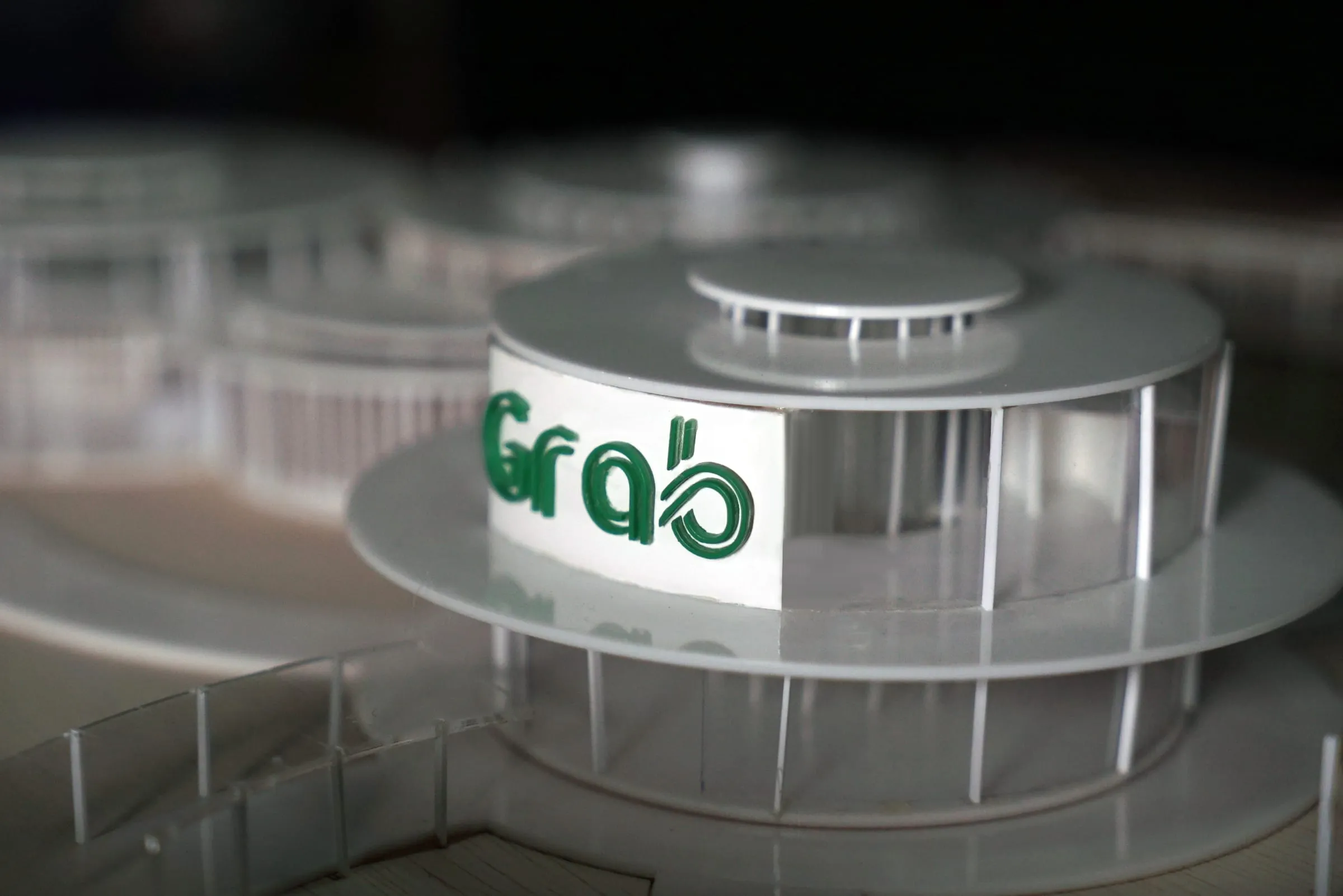 Physical model of stacked circular pavilions with the Grab logo